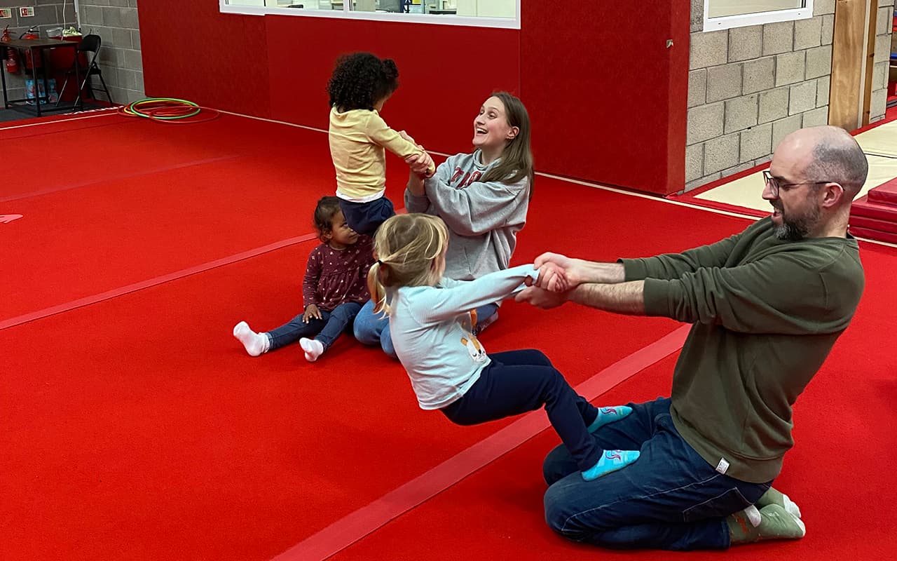 Toddlers and parents enjoying pre-school gymnastics class