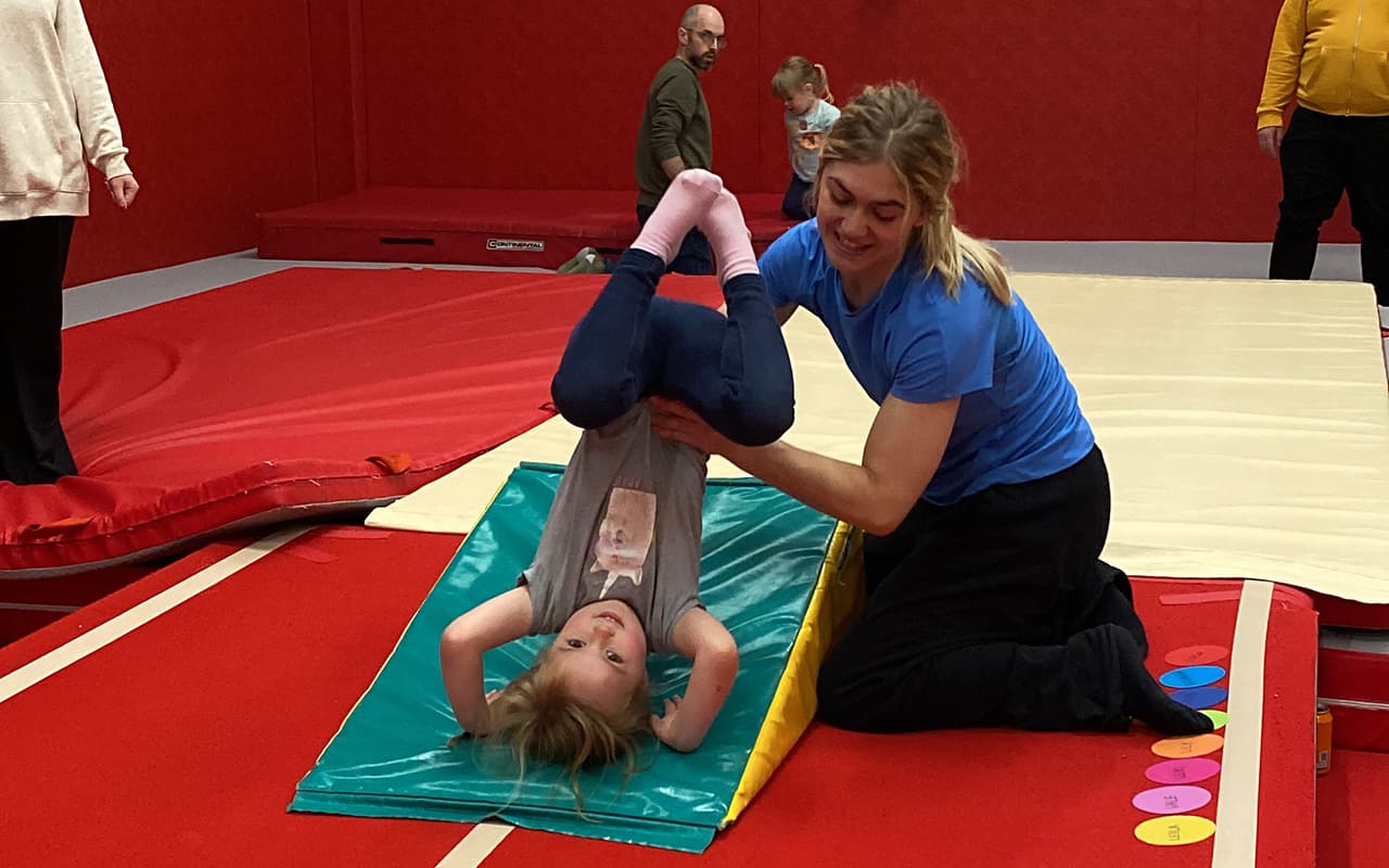 Toddler enjoying pre-school gymnastics class