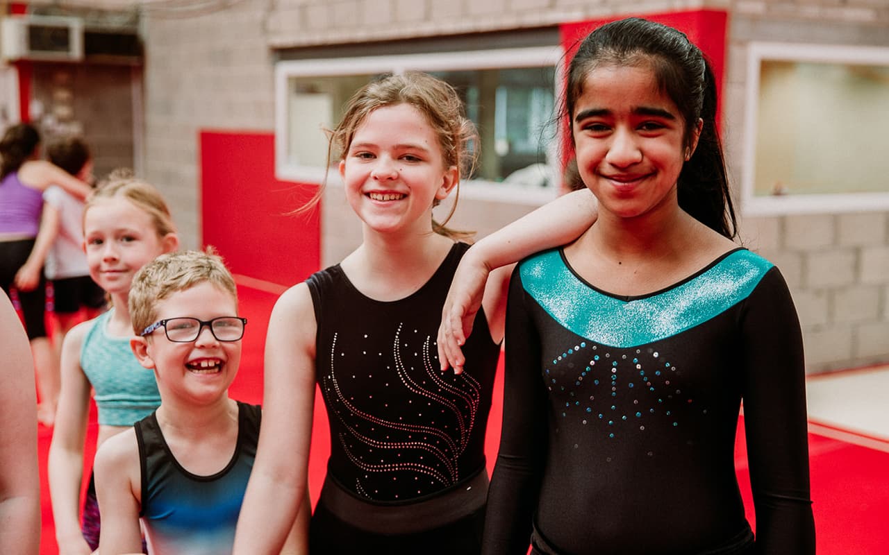 Kids smiling during children's gymnastics class