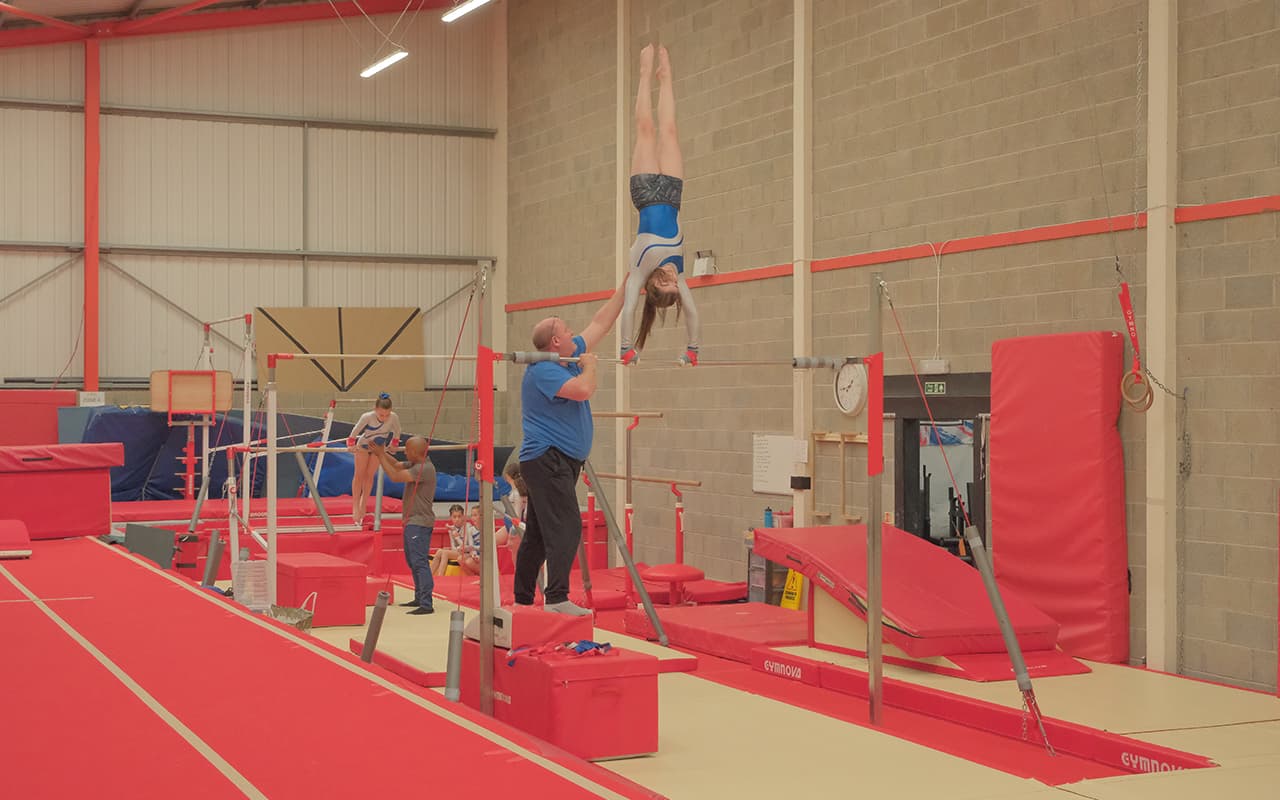 Girls training on bars for gymnastics four piece squad team