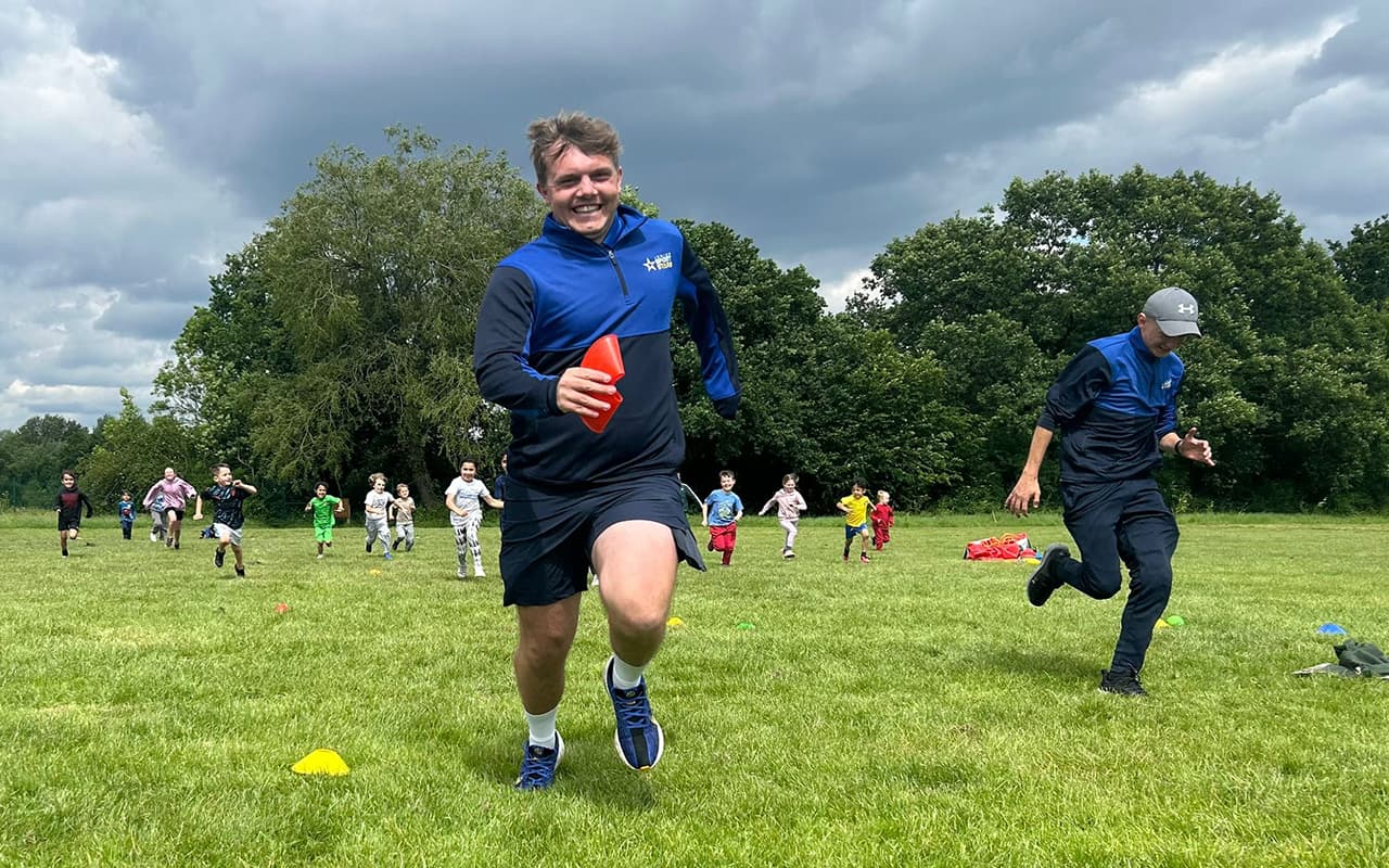 Children chasing our team members across a field