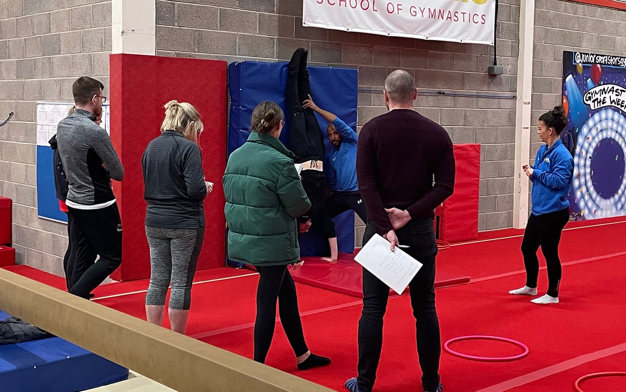 Coach instructing CPD group in physical education