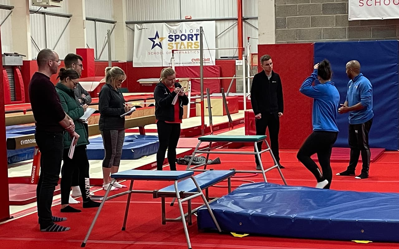 Coach instructing CPD group in physical education