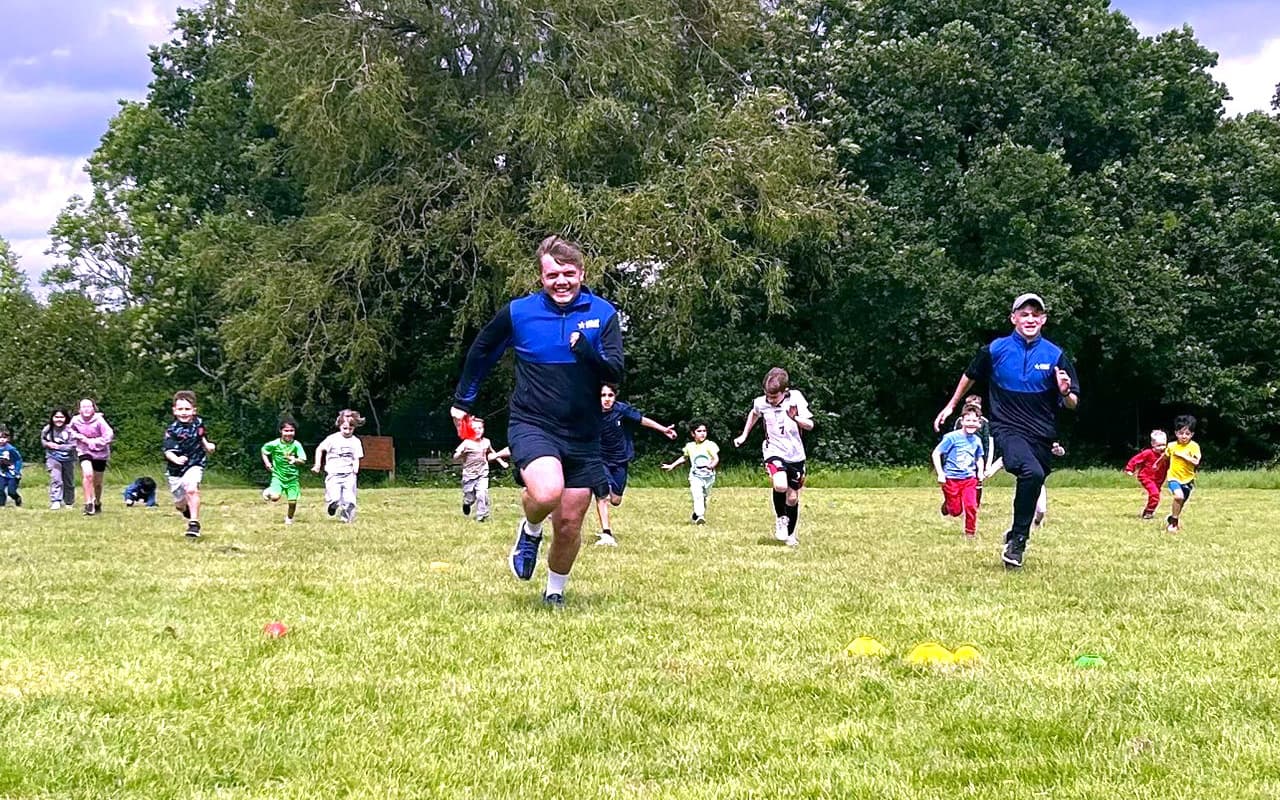 Children chasing our team members across a field