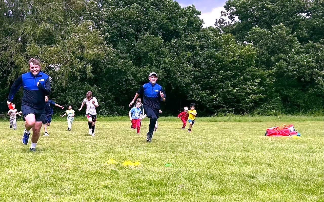Children chasing our team members across a field