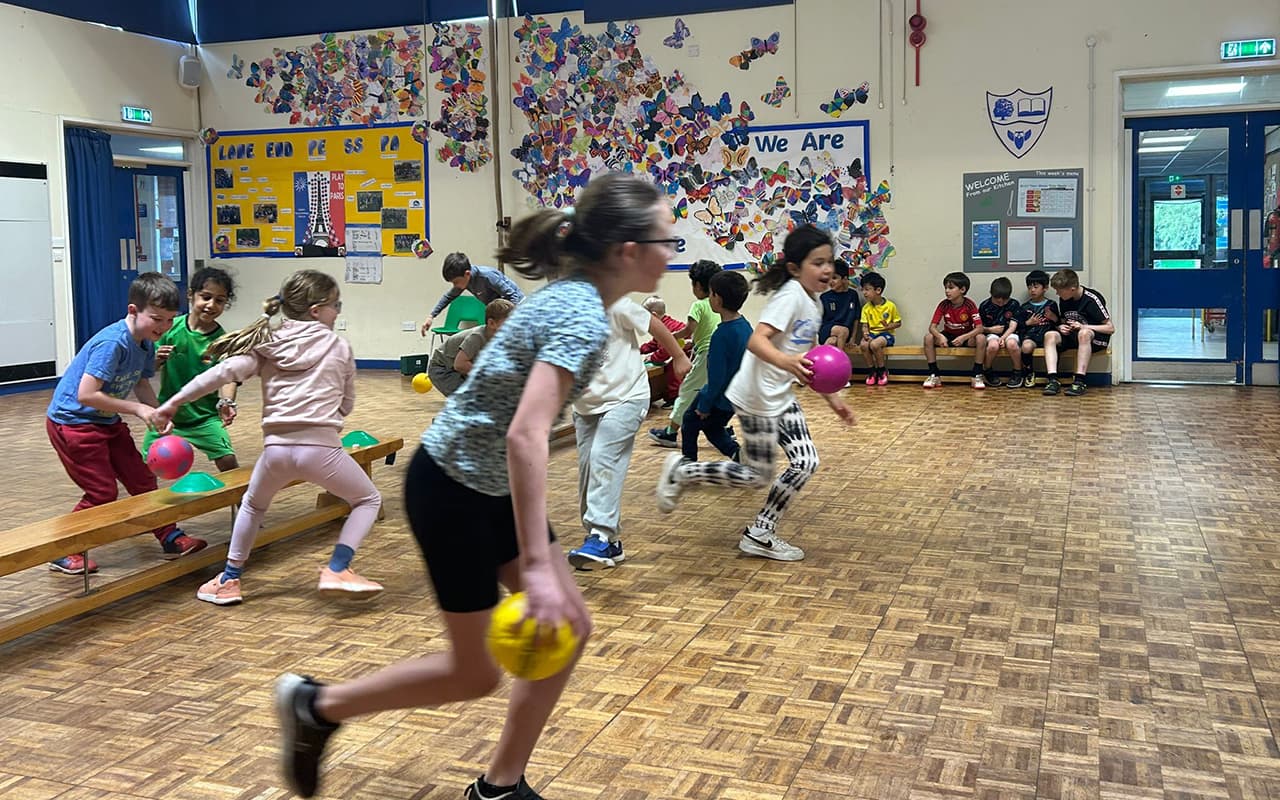 Children playing sports in a sports hall