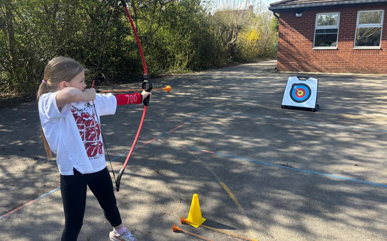 girl taking part in archery